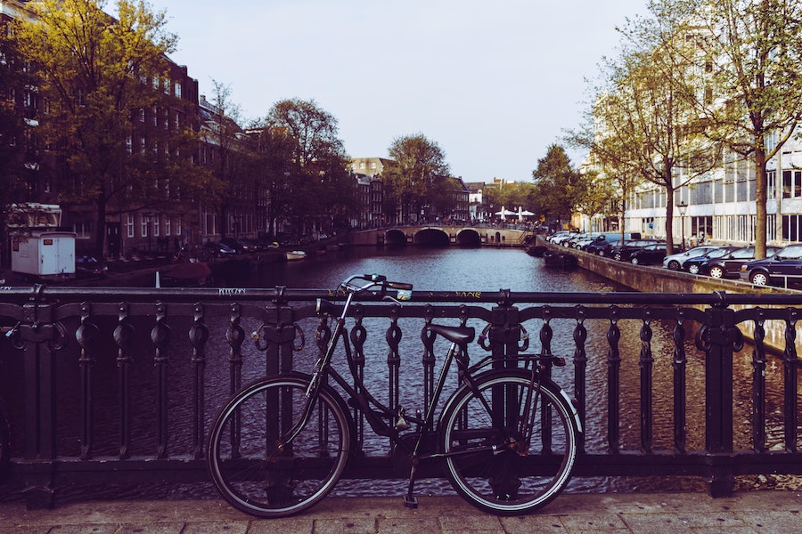 Visite d'Amsterdam à vélo. Vélo posé contre la rambarde du pont